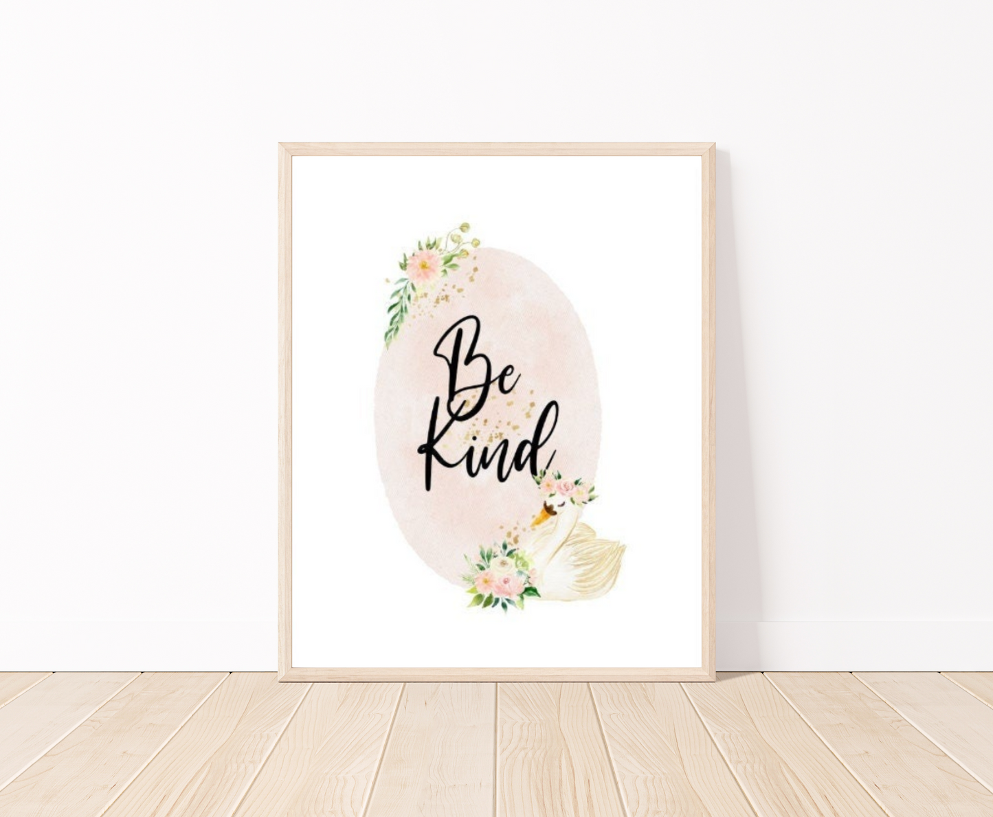 A digital graphic showing a baby pink oval shape decorated with flowers on the top and the bottom of the shape and beside the flowers at the bottom there is a cute goose illustration, with the phrase “Be Kind” written in black text inside the emblem.