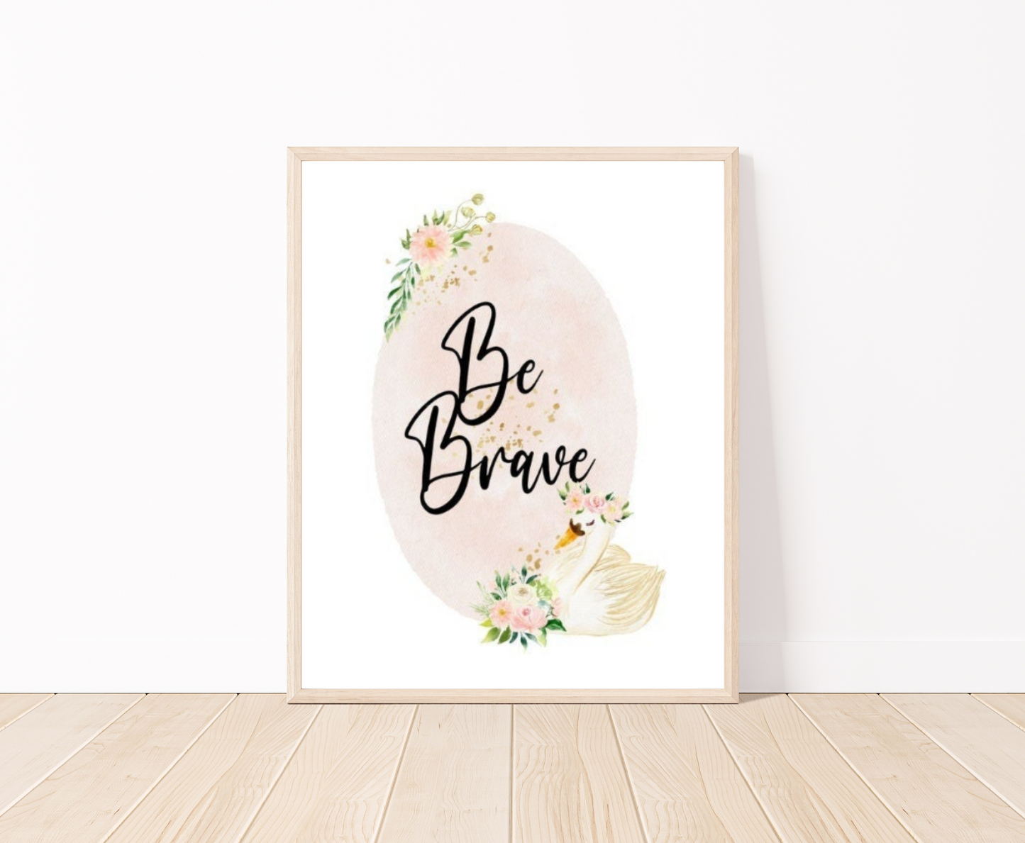 A digital graphic showing a baby pink oval shape decorated with flowers on the top and the bottom of the shape and beside the flowers at the bottom there is a cute goose illustration, with the phrase “Be Brave” written in black text inside the emblem.