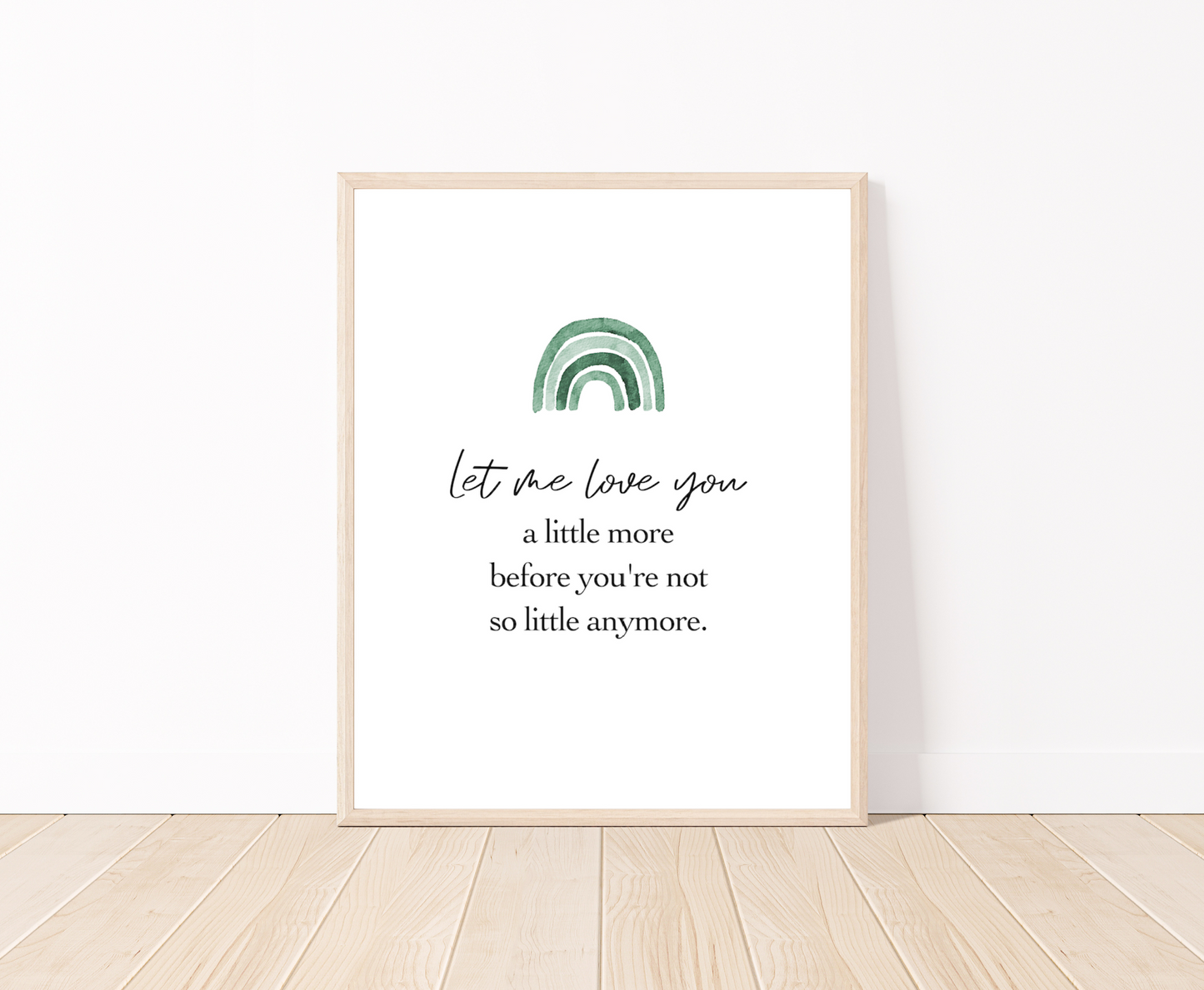 A digital placed on the floor showing a green ombre rainbow on top with a piece of writing below saying: let me love you a little more before you are not little anymore.