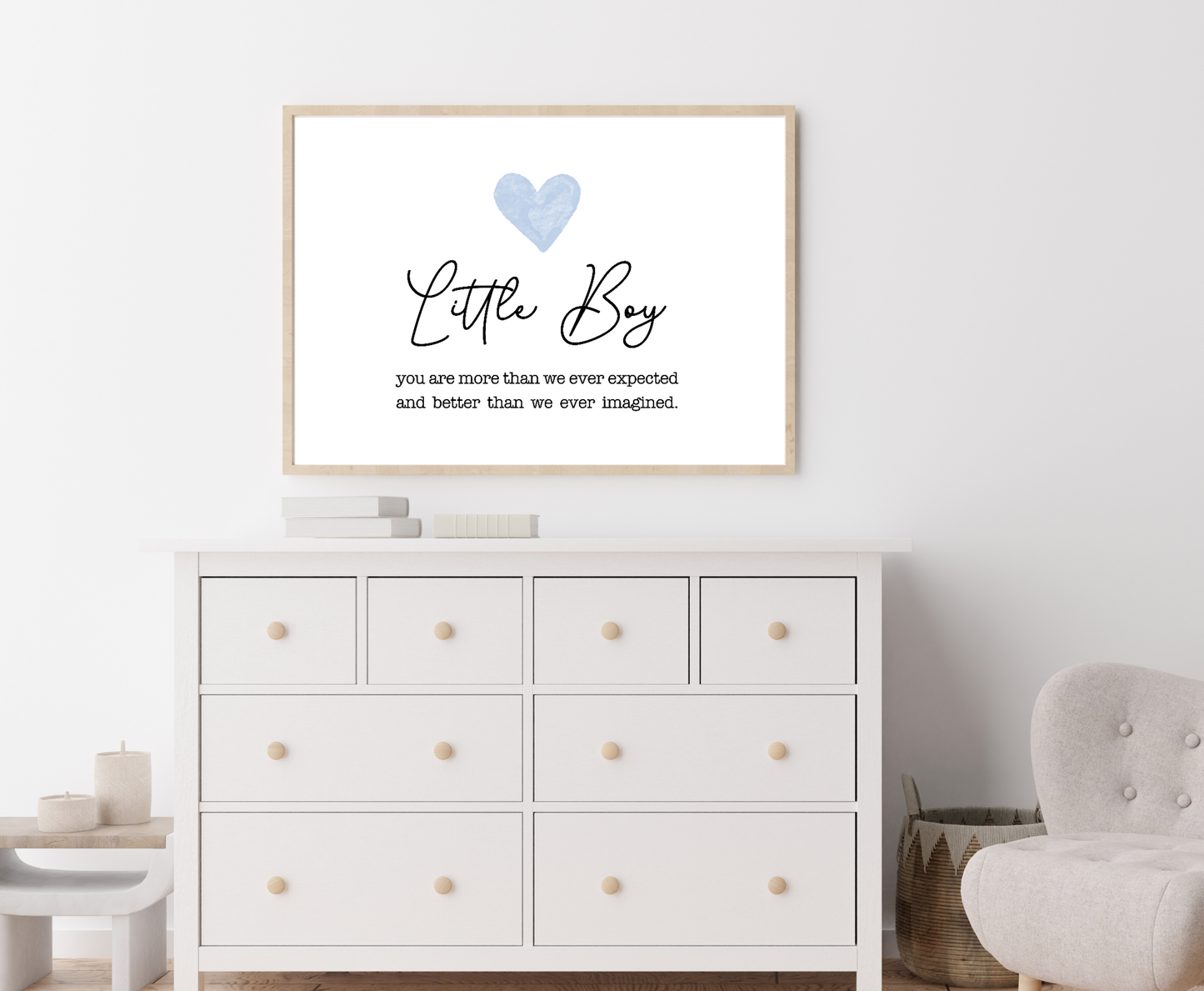 A picture showing a white dresser with a digital poster hung above it. The poster shows a blue heart on top with a piece of writing below saying: Little boy, you are more than we ever expected, and better we ever imagined.