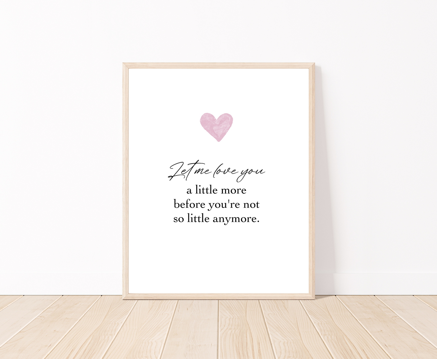 A digital poster is placed on a white wall and parquet flooring and has a pink heart at the top with a piece of writing that says: “Let me love you, a little more before you’re not so little anymore.”