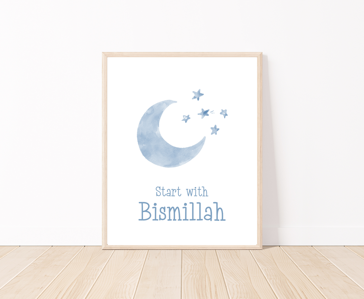 A little boy’s room digital poster that is placed on a white wall and parquet flooring shows a baby blue crescent and some tiny stars with “Start with Bismillah” written right below.