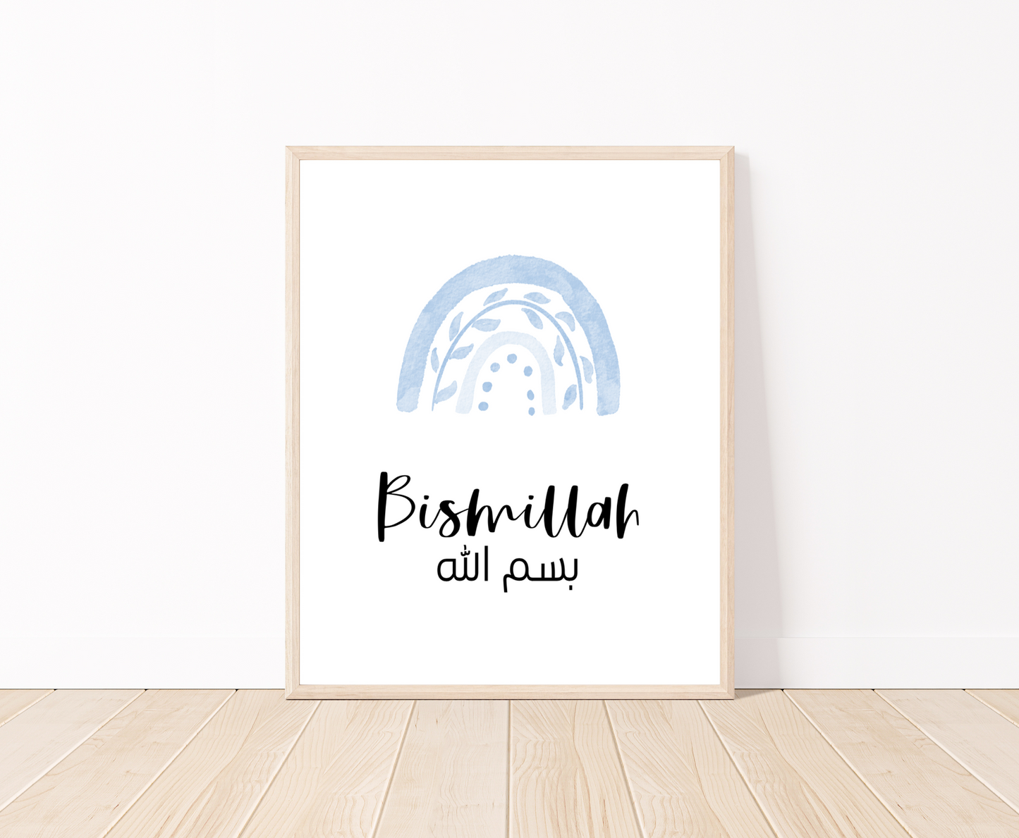 A digital print placed on a white wall and parquet flooring showing a blue rainbow with a piece of writing below that says: “Bismillah”.