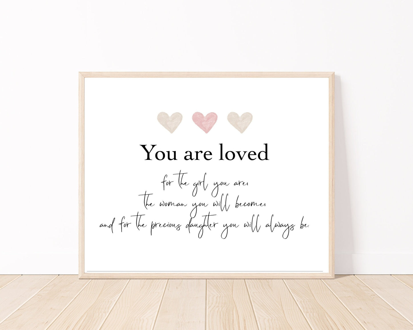 A little girl’s graphic showing three baby pink and beige hearts with a piece of writing below that says: You are loved, for the girl you are, the woman you will become, and for the precious daughter you will always be.