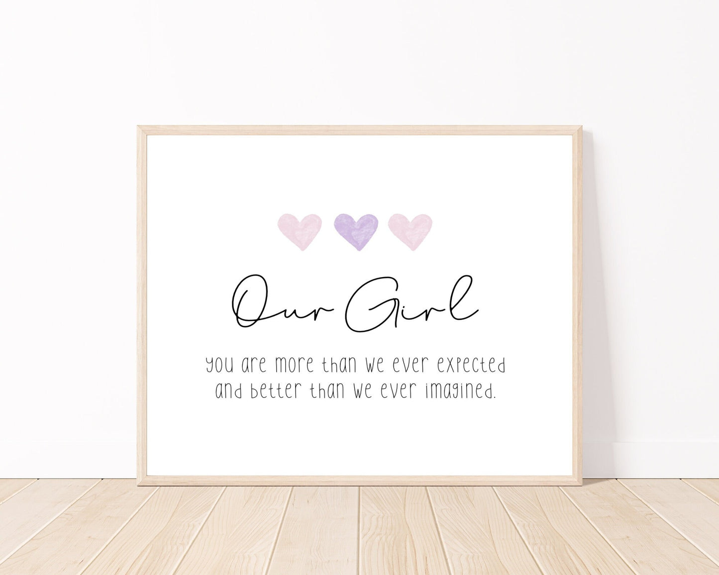A little girl’s graphic showing three baby pink and purple hearts with a piece of writing below that says: Our girl, you are more than we ever expected, and better than we ever imagined.