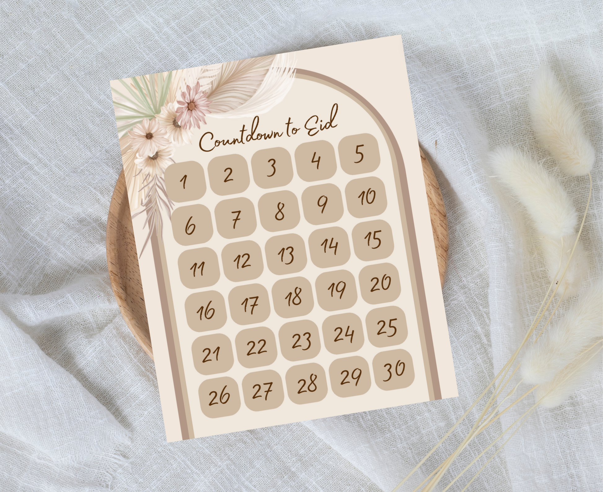 Countdown to Eid print on a neutral cloth background and round wooden tray. 