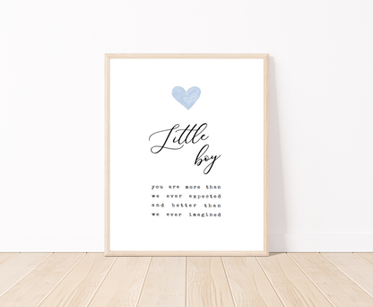 A digital poster placed on a white wall and parquet flooring that has a blue heart at the top, and a piece of writing that says: “Little boy, you are more than we ever expected and better than we ever imagined.”