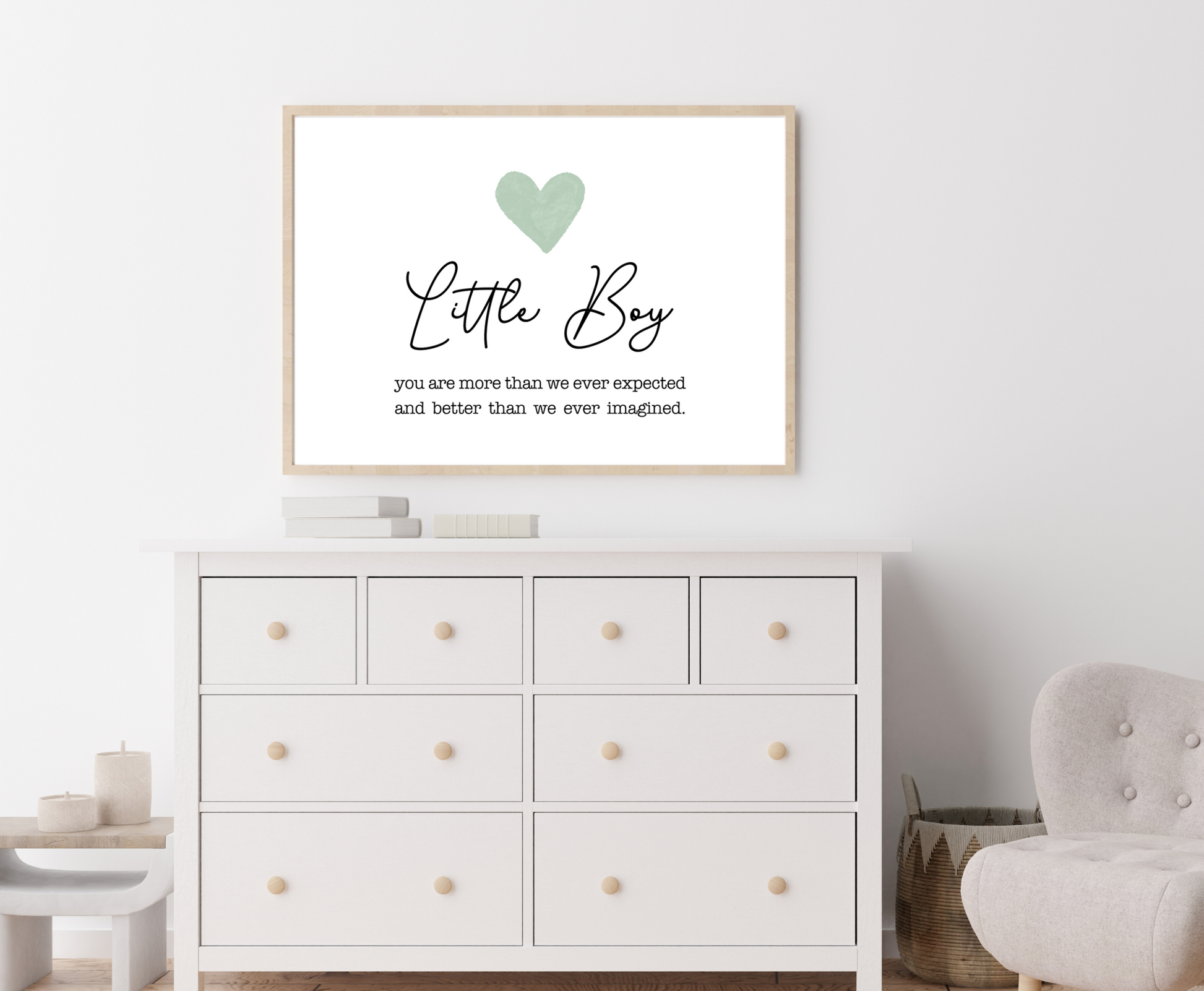 An image of a white dresser with a frame hanging on the wall behind it. The frame displays a baby green heart with a piece of writing below that says: you are more than we expected and better than we ever imagined.