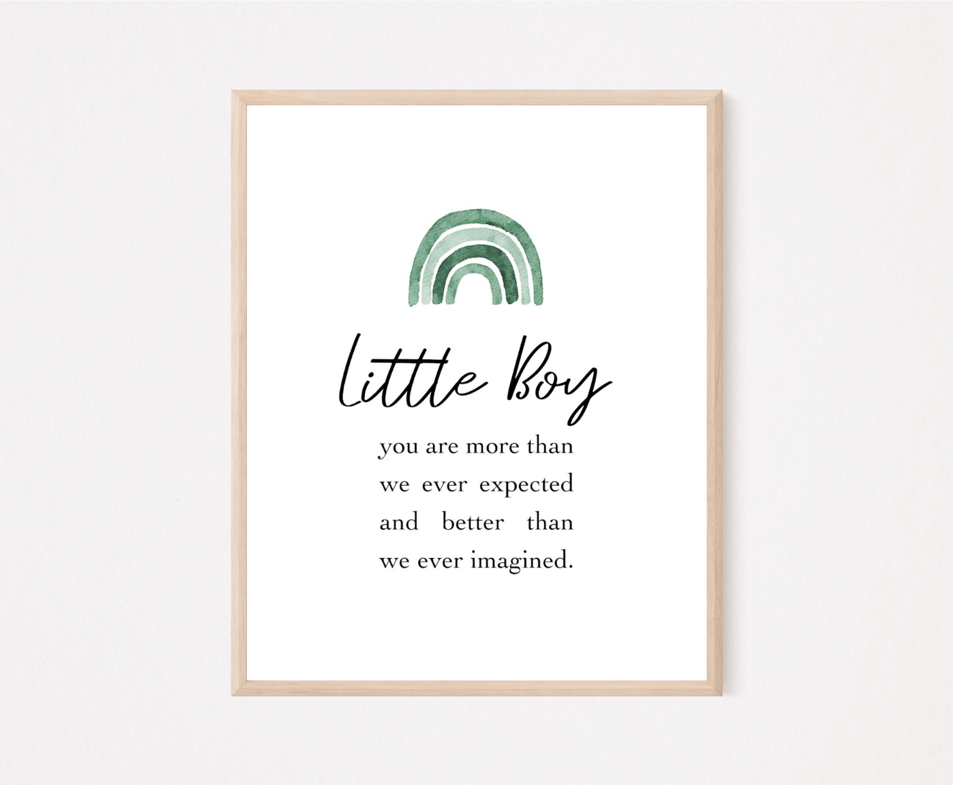 A frame showing a graphic for a little boy’s room displaying a rainbow design in different shades of green  and includes a piece of writing that says: Little boy, you are more than we ever expected and better than we ever imagined.