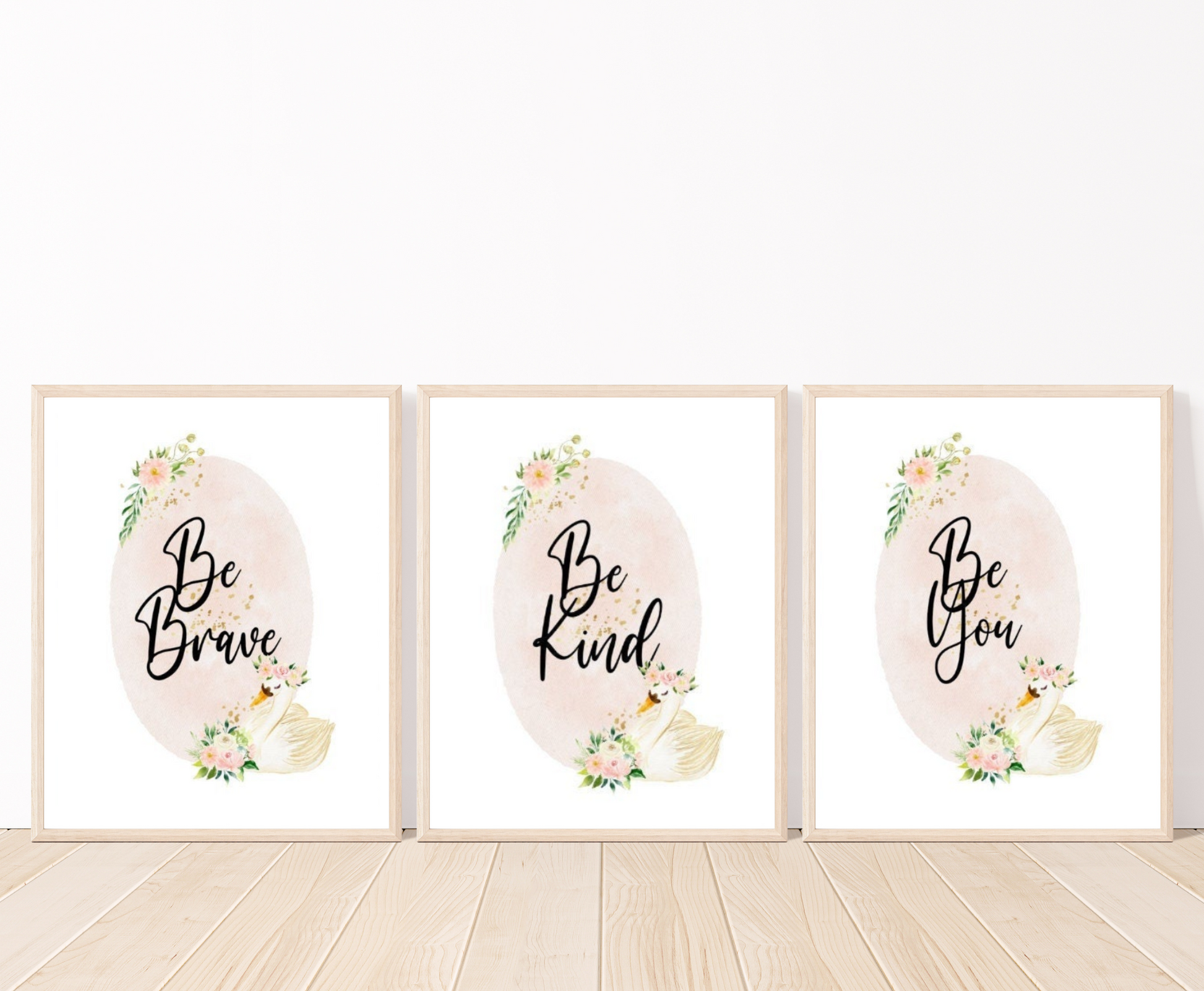 Three identical digital graphics but have different writings showing a baby pink oval shape decorated with flowers on the top and the bottom of the shape and beside the flowers at the bottom there is a cute goose illustration. The first graphic says” Be Brave”, the second “Be Kind”, and the third “Be You”. All these frames are placed on a parquet floor. 