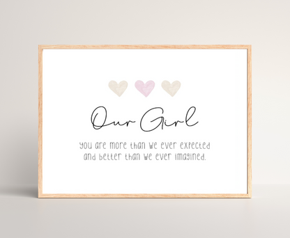 A little girl’s graphic showing three baby pink and beige hearts with a piece of writing below that says: Our girl, you are more than we ever expected, and better than we ever imagined.
