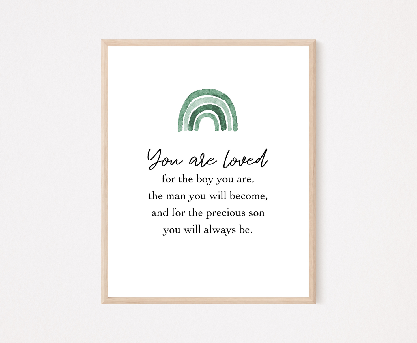 A frame showing a graphic for a little boy’s room that has an ombre green rainbow design and includes the following “You are loved, for the boy you are, the man you will become, and for the precious son you will always be.” 
