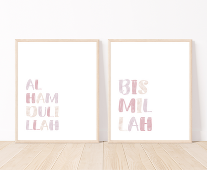 Two little girl’s room digital prints with a white background that are placed on a white wall and parquet flooring. The first one includes “Alhamdulillah” written in upper case and multi-colored letters. The second one includes “Bismillah” written in upper case and multi-colored letters.