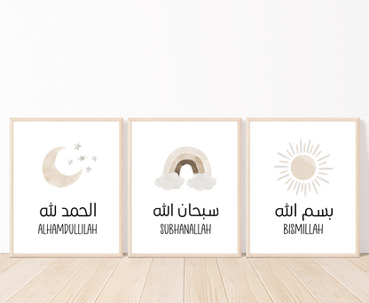 An image showing three digital print graphics that are placed on a white wall and parquet flooring. The first one shows a graphic of a light brown crescent and some tiny stars with “Alhamdulillah” written in both Arabic and English right below. The middle is a light brown rainbow with “Subhanallah” in both Arabic and English written just below it. The first one is for a light brown sun with “Bismillah” written in both Arabic and English.