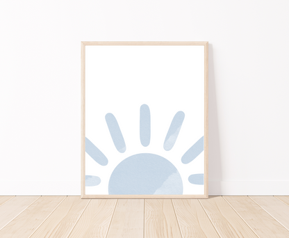 A digital poster is placed on a white wall and parquet flooring and shows a baby blue sun at the base of the frame.