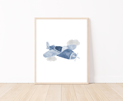 A digital poster is placed on a white wall and parquet flooring and shows a baby blue airplane and two gray clouds.