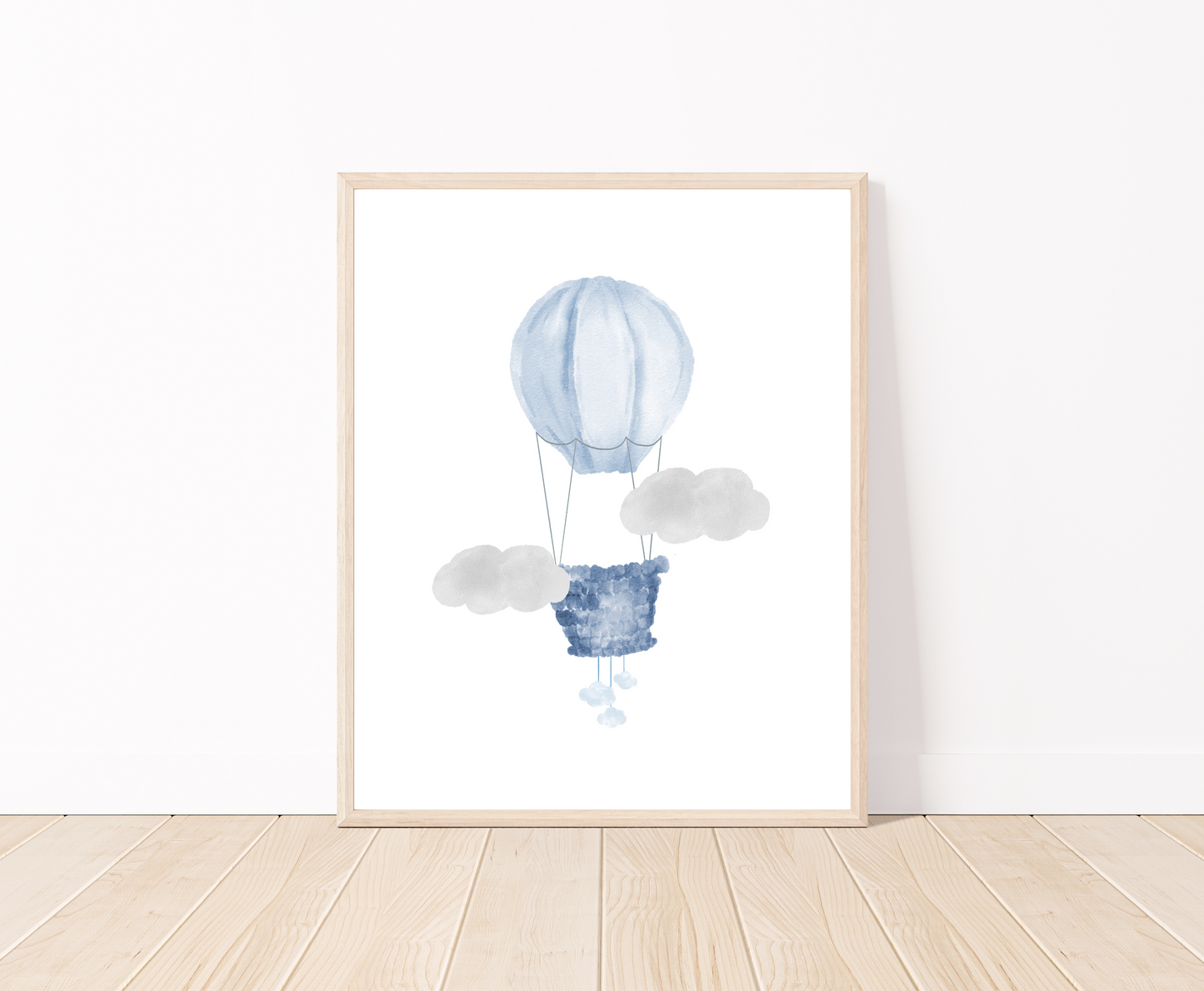 A digital poster is placed on a white wall and parquet flooring and shows a baby blue air balloon and two gray clouds.