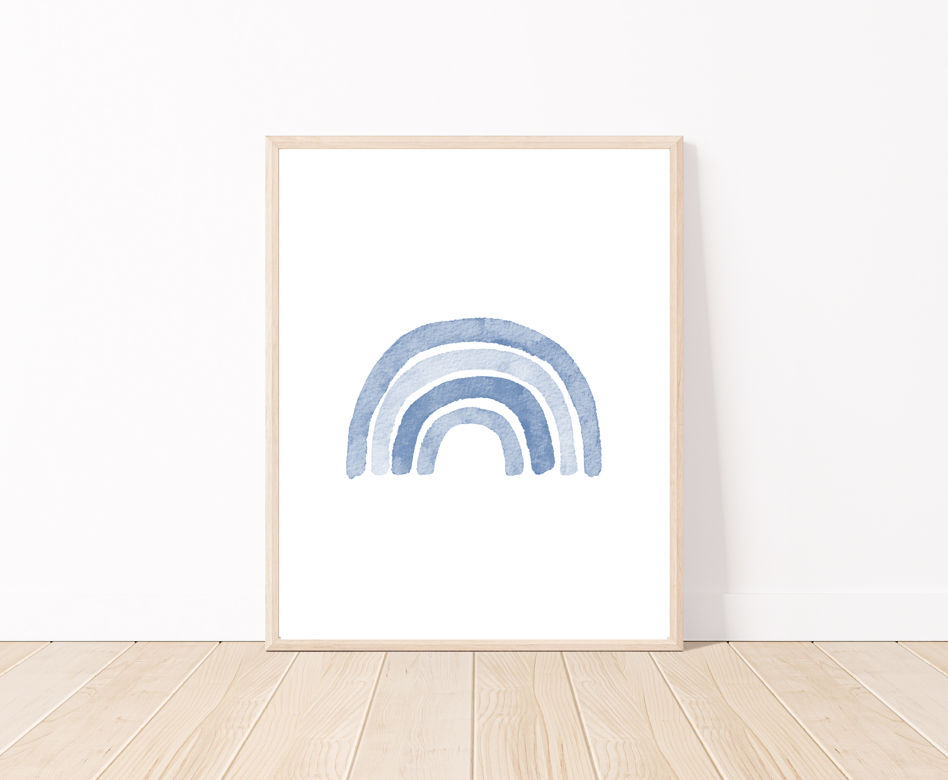 A digital poster is placed on a white wall and parquet flooring and shows a baby blue rainbow.