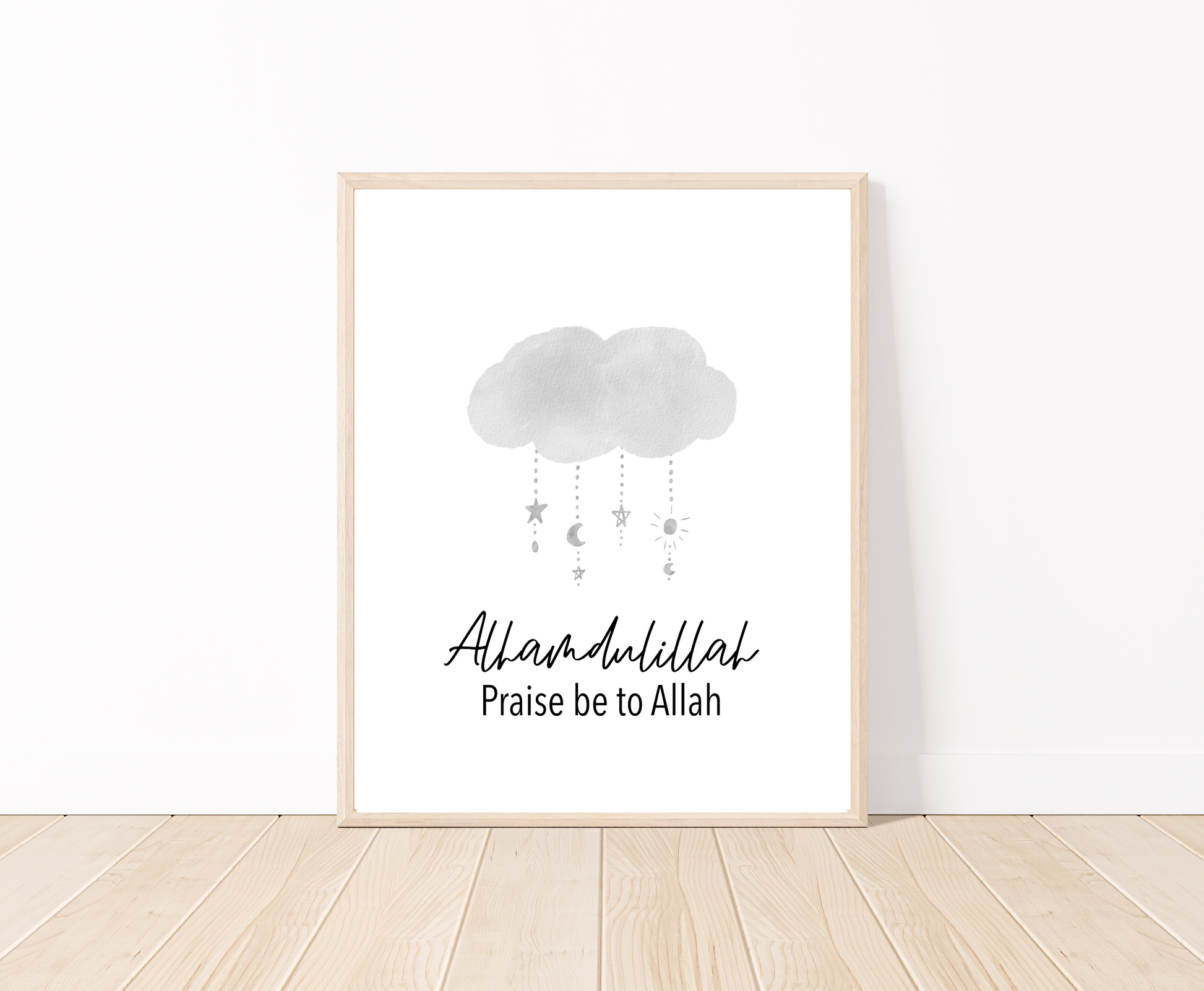 A little boy’s room digital poster that is placed on a white wall and parquet flooring shows a gray cloud design with the word “Alhamdulillah”, Praise Be to Allah below.