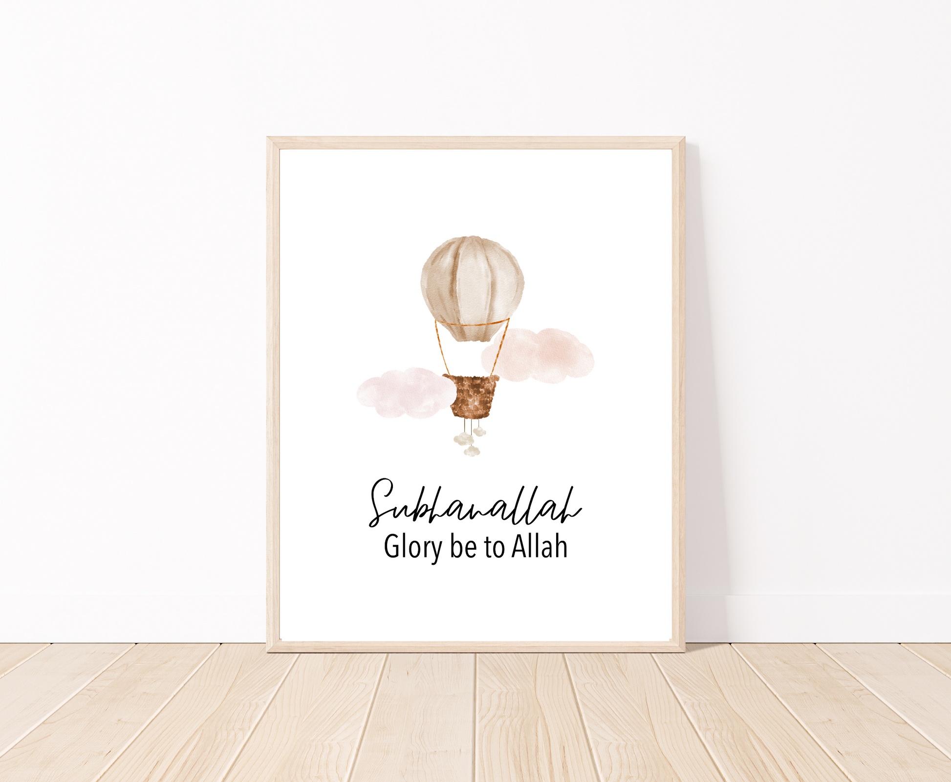 A digital poster that is placed on a white wall and parquet flooring shows a light brown air balloon with two pink clouds and the word “Subhanallah”, Glory Be to Allah, written below.