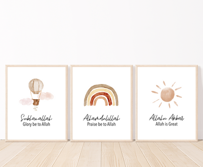 Three frames with three different graphics that are placed on a white wall and parquet flooring. The first one shows a light brown air balloon with the word “Subhanallah”, Glory Be to Allah, written below. The middle one shows a different degree brown rainbow design with the word “Alhamdulillah”, Praise Be to Allah below. The last one shows a brown pinkish sun with the word “Allahu Akbar”, Allah is great, written below.