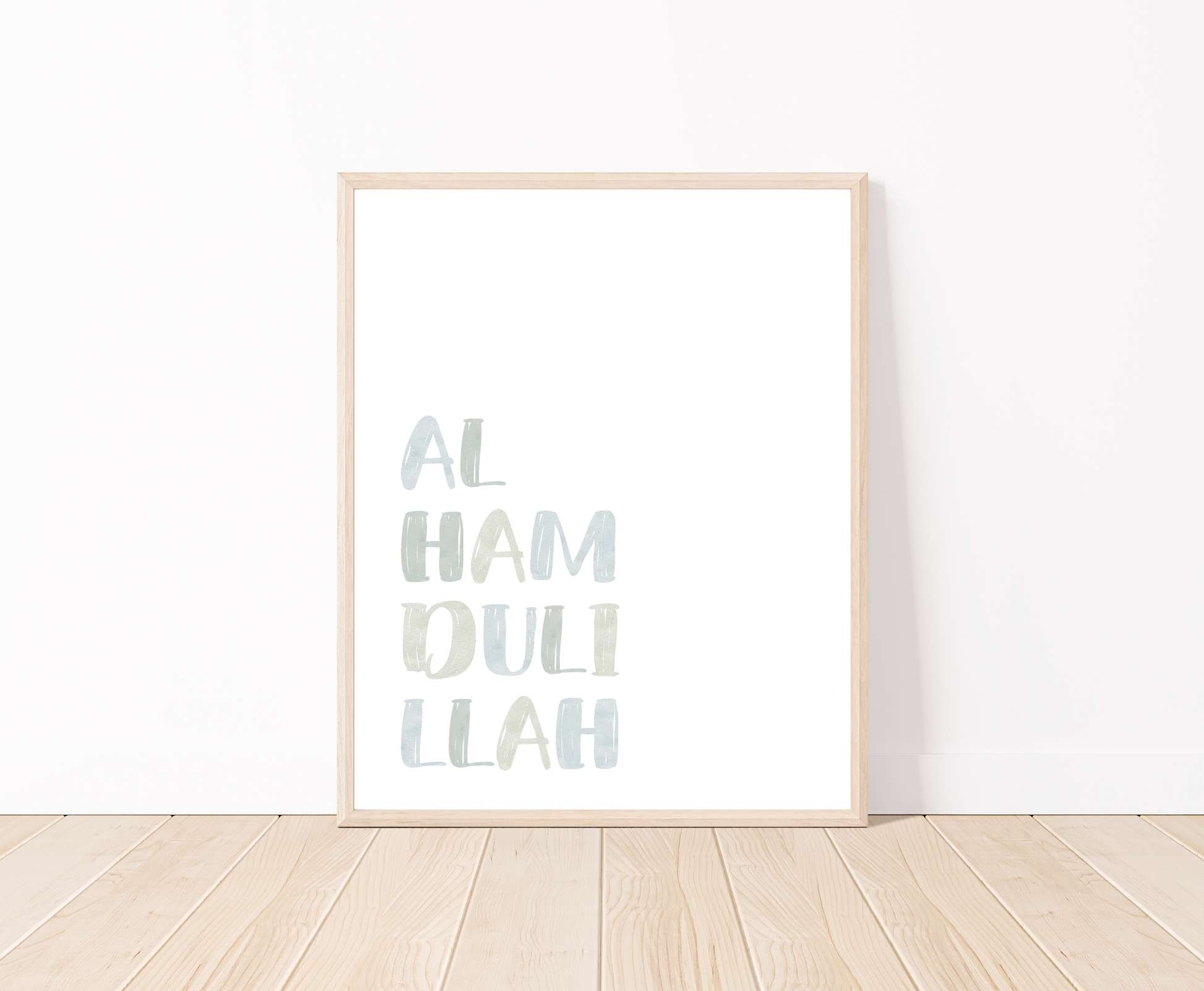 A little boy’s room digital print is placed on a white wall and parquet flooring. It includes “Alhamdulillah” written in upper case and multi-colored letters with a white background.
