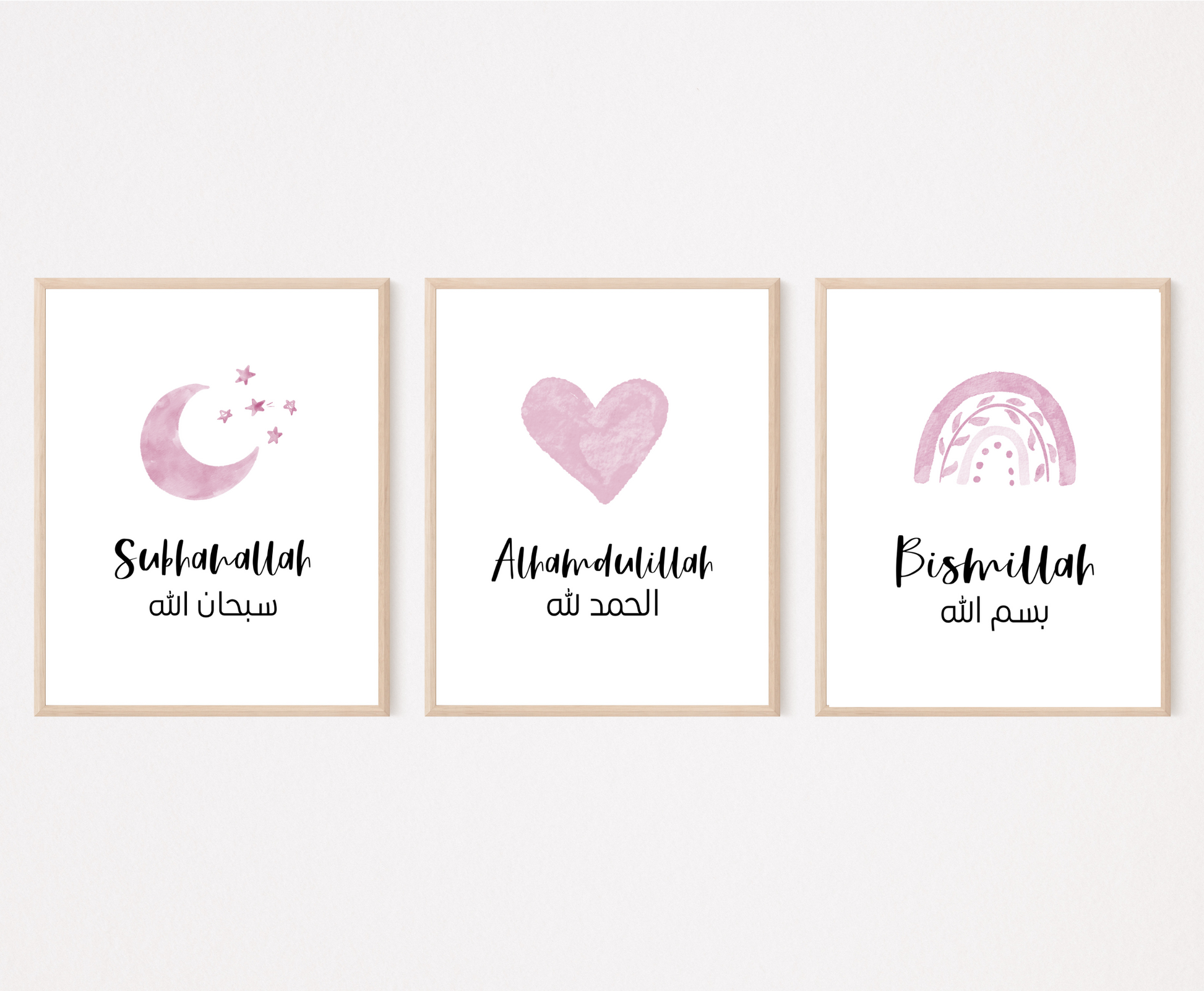 Three frames showing graphics for a baby girl’s room. The first one shows a small pink moon and three small stars with a piece of writing below that says: “Subhanallah”. The middle graphic shows a pink heart with a piece of writing below that says: “Alhamdulillah”. The last one shows a pink rainbow with a piece of writing below that says: “Bismillah”.