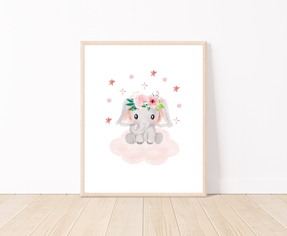 A digital print placed on a white wall and parquet flooring showing a design for a cute baby elephant printing that has a flower crown on its head and is sitting on a pink cloud with mini stars surrounding its head 