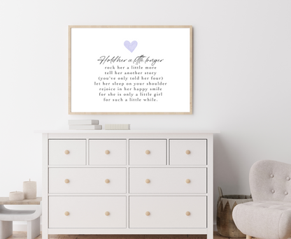 A digital print is placed above a nursery wardrobe. The digital print has a purple heart at the top and a piece of writing that says: Hold her a little longer, rock her a little more, tell her another story, (you have only told her four), let her sleep on your shoulder, rejoice in her happy smile, for she is only a little girl, for such a little while.