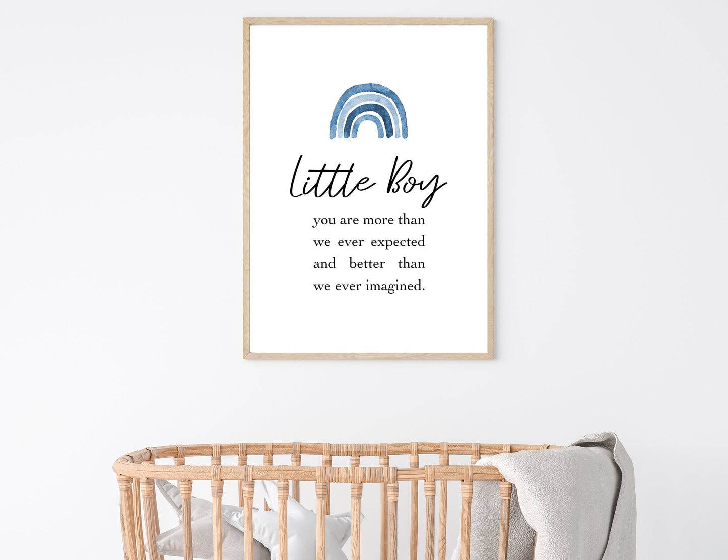 A picture showing a digital poster hung on the wall above a cradle. The digital poster has a blue rainbow, with a piece of writing that says: “Little boy, you are more than we ever expected and better than we ever imagined.”