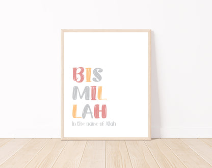 A digital print is placed on a white wall and parquet flooring. It includes “Bismillah, in the name of Allah” written in multi-colored letters with a white background.
