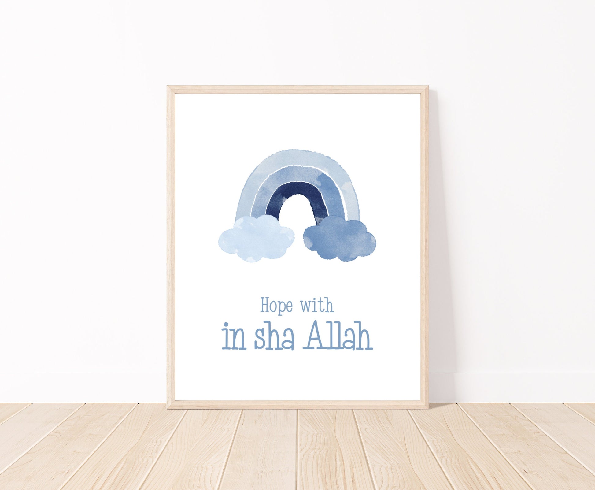 A digital poster that is placed on a white wall and parquet flooring shows a baby blue rainbow with “Hope with In Sha Allah” written just below it.