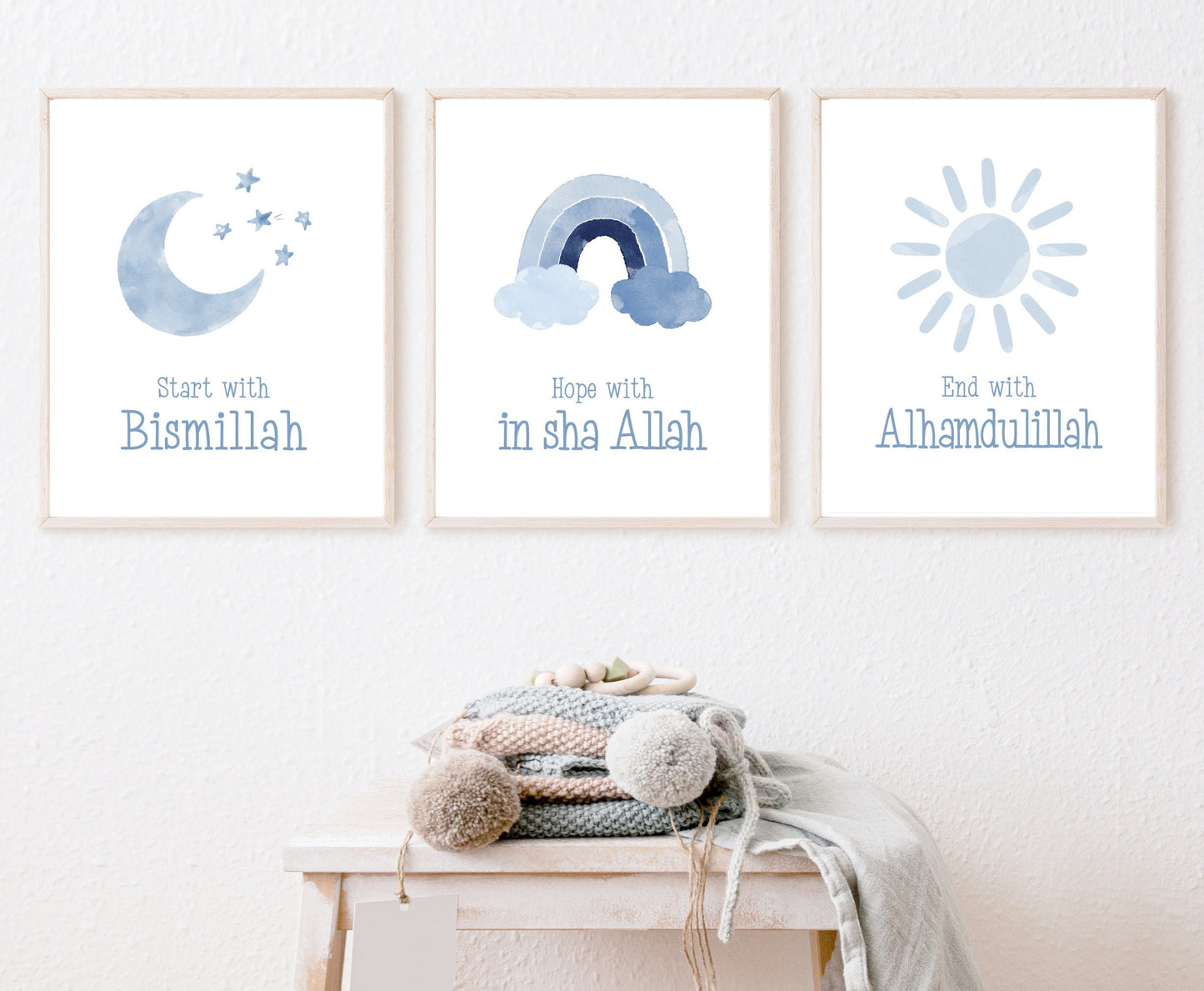 An image showing three digital print graphics that are hung on a wall. The first one shows a baby blue crescent and some tiny stars with “Start with Bismillah” written right below. The middle graphic is a baby blue rainbow with “Hope with In Sha Allah” written just below it. The last frame shows a graphic of a baby blue sun with “End with Alhamdulillah” written just below the latter.