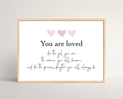 A digital poster that has three pink hearts at the top with a piece of writing that says: “You are loved for the girl you are, the woman you will become, and for the precious daughter you will always be.”
