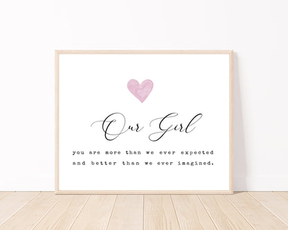 A little girl’s graphic showing a pink heart with a piece of writing below that says: Our girl, you are more than we ever expected, and better than we ever imagined.