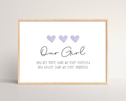 A little girl’s room digital print that has three purple hearts at the top, and a piece of writing that says: “Our girl, you are more than we ever expected and better than we ever imagined.”