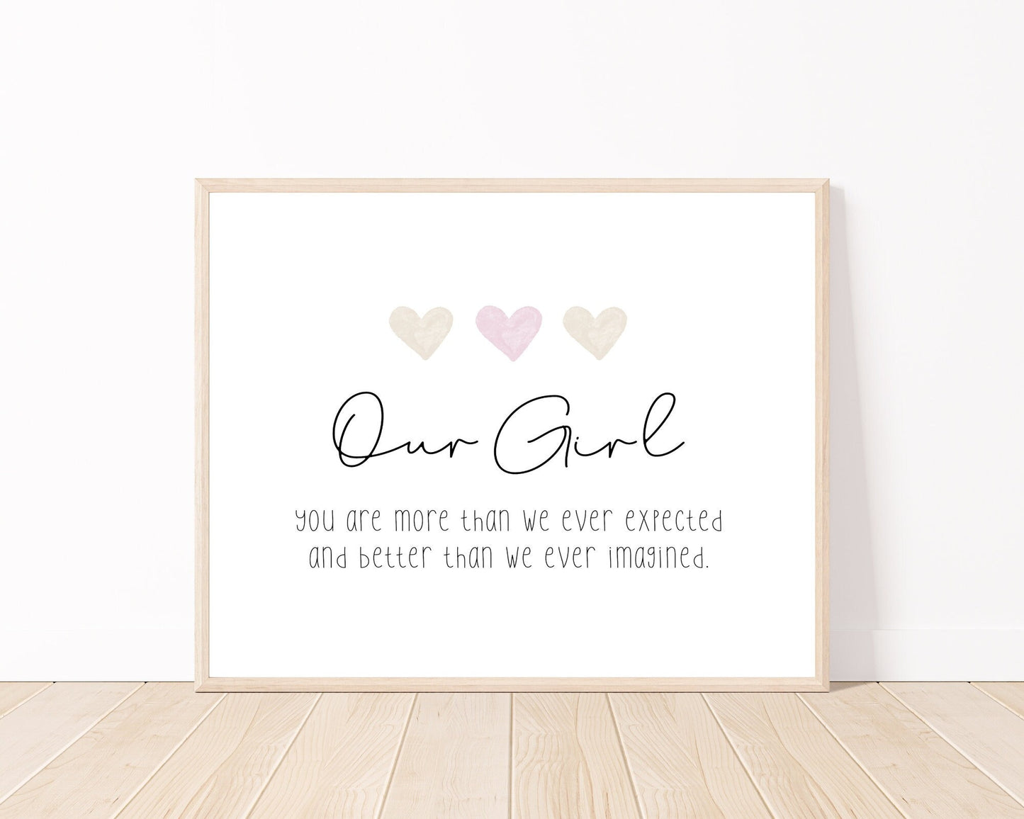 A little girl’s graphic showing three baby pink and beige hearts with a piece of writing below that says: Our girl, you are more than we ever expected, and better than we ever imagined.