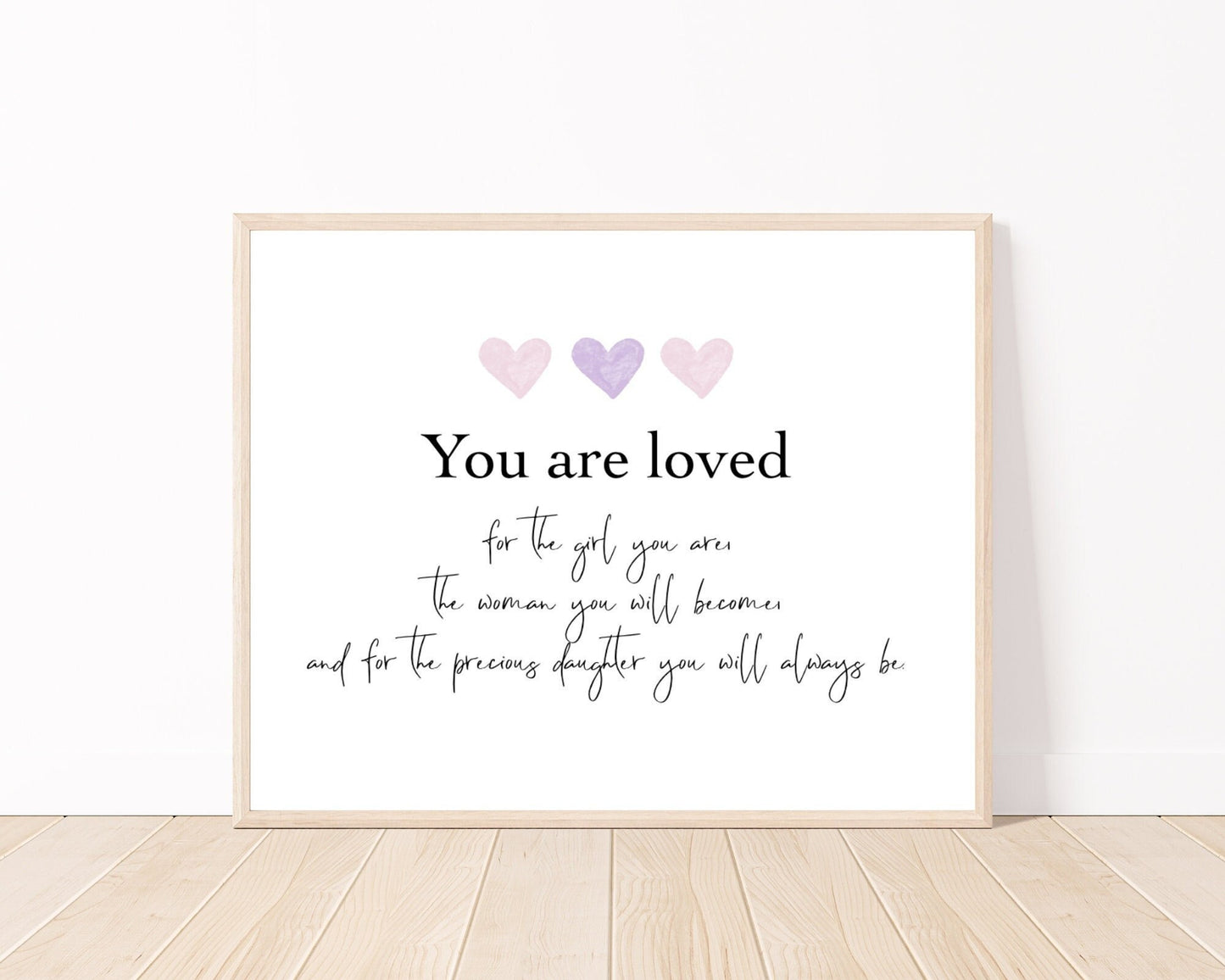 A little girl’s graphic showing three baby pink and purple hearts with a piece of writing below that says: You are loved, for the girl you are, the woman you will become, and for the precious daughter you will always be.