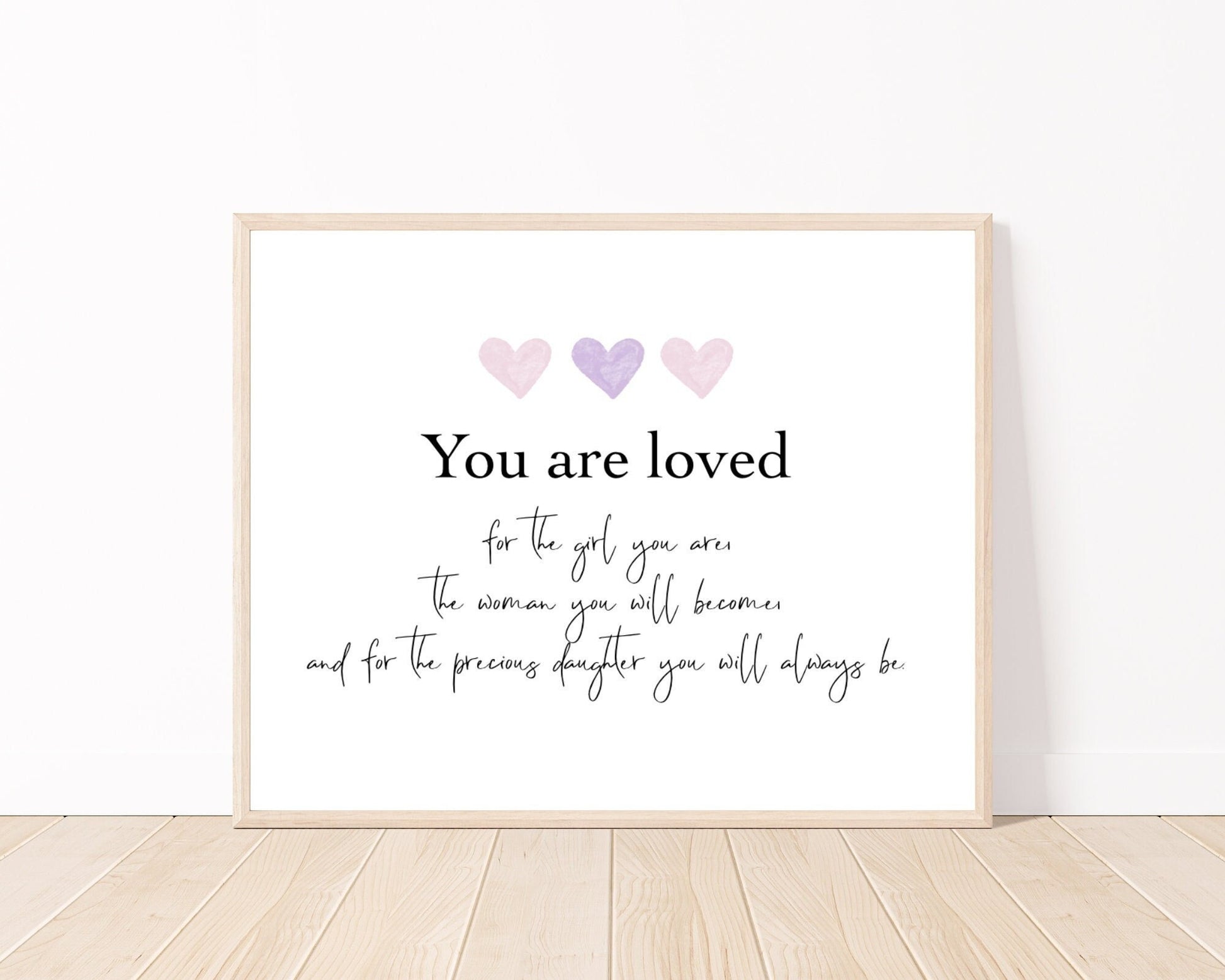 A little girl’s graphic showing three baby pink and purple hearts with a piece of writing below that says: You are loved, for the girl you are, the woman you will become, and for the precious daughter you will always be.