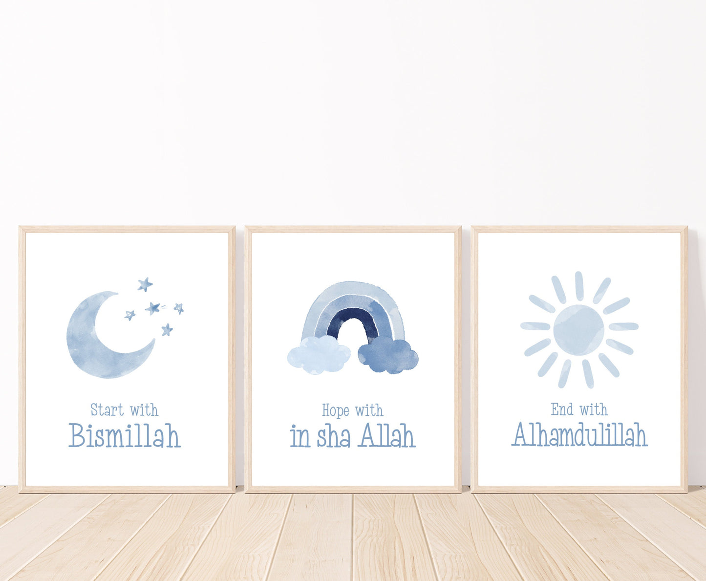 An image showing three digital print graphics that are placed on a white wall and parquet flooring. The first one shows a baby blue crescent and some tiny stars with “Start with Bismillah” written right below. The middle graphic is a baby blue rainbow with “Hope with In Sha Allah” written just below it. The last one shows a graphic of a baby blue sun with “End with Alhamdulillah” written just below the latter.