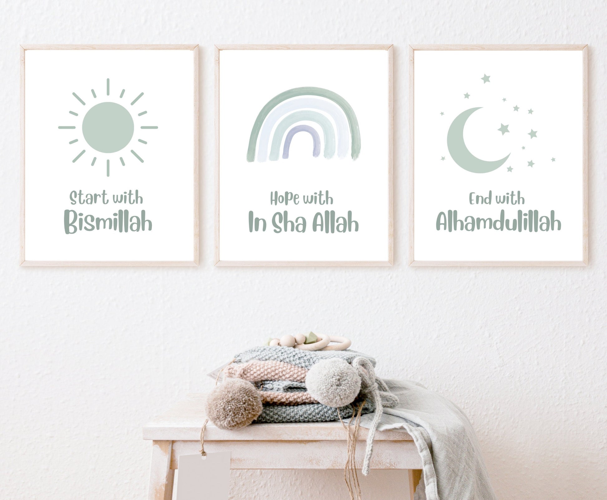 An image showing three digital print graphics that are hanging on a wall. The first one shows a baby green sun with “Start with Bismillah” written in the same color, right below. The middle graphic is a baby green rainbow with “Hope with In Sha Allah” written just below it. The last frame shows a graphic of a baby green crescent and some tiny stars in the same color with “End with Alhamdulillah” written just below the latter.